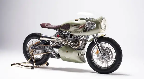 Stuning custom Triumph Thruxton 900 w kolorze oliwkowym, z brązową, pikowaną kanapą i chromowanymi detalami.