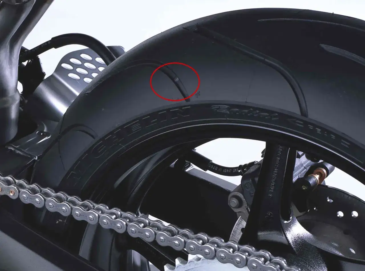 Uszkodzona opona motocyklowa Michelin. Zastanawiasz się, ile km wytrzymują opony? To zależy od wielu czynnik&oacute;w.